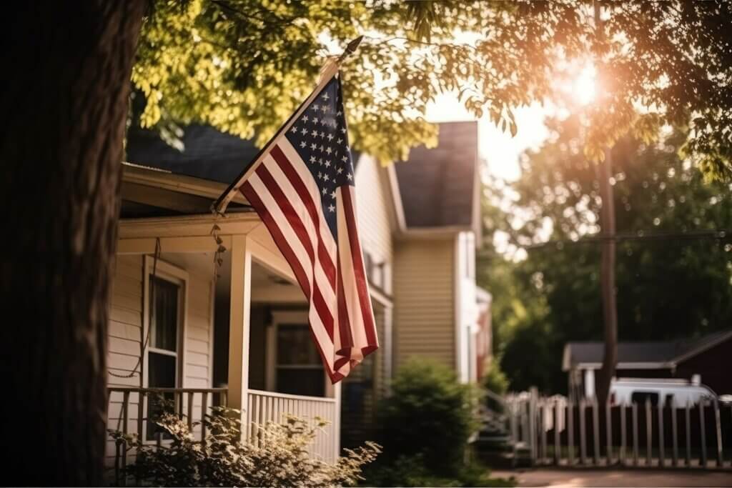 American flag flying from the front porch of a house.