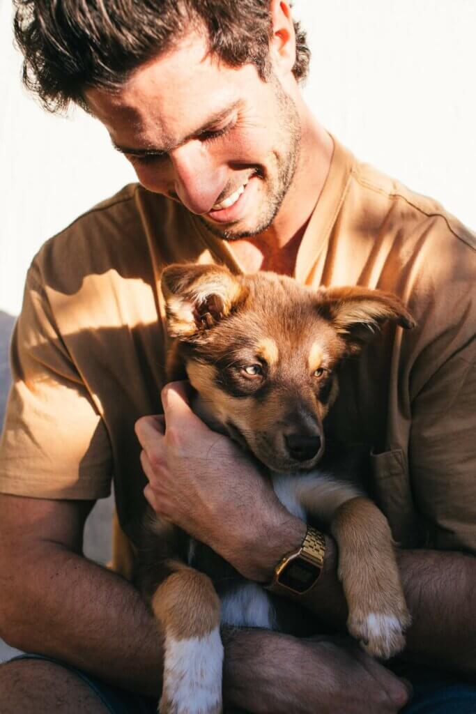 Happy man holding a dog.